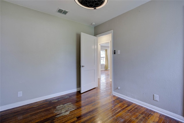 unfurnished room featuring dark wood-type flooring