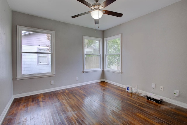 unfurnished room with ceiling fan and dark hardwood / wood-style flooring