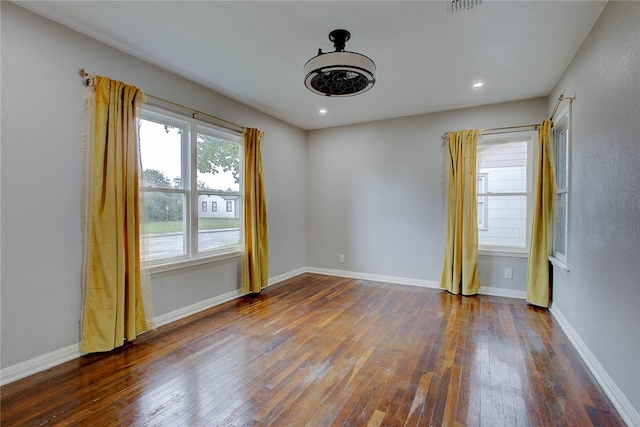 empty room with dark wood-type flooring