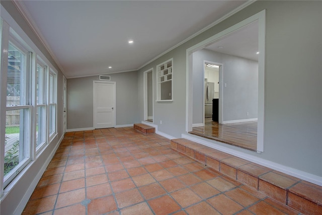 unfurnished room featuring crown molding