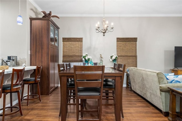 dining area with dark hardwood / wood-style flooring, a notable chandelier, and ornamental molding