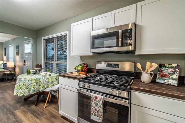 950 Susan Dr, Corpus Christi, TX 78412 - kitchen with appliances with stainless steel finishes, wooden counters, dark wood finished floors, and white cabinets
