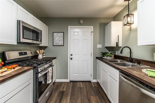 950 Susan Dr, Corpus Christi, TX 78412 - kitchen featuring stainless steel appliances, wood counters, a sink, dark wood-style flooring, and white cabinets