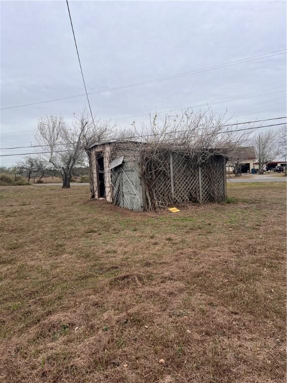 view of outbuilding featuring a yard