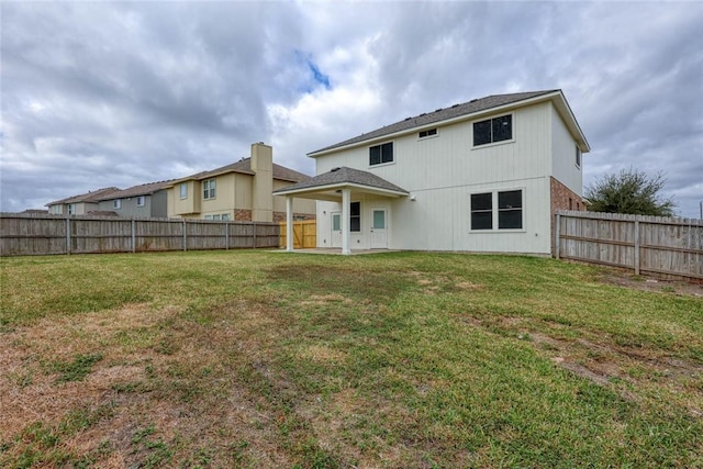 rear view of house with a yard