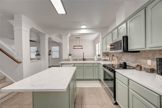 kitchen featuring green cabinetry, decorative light fixtures, a kitchen island, electric range oven, and light tile patterned flooring