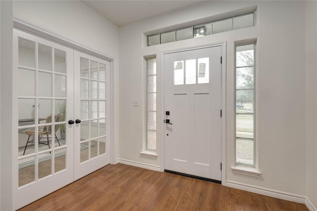 foyer with wood-type flooring and french doors