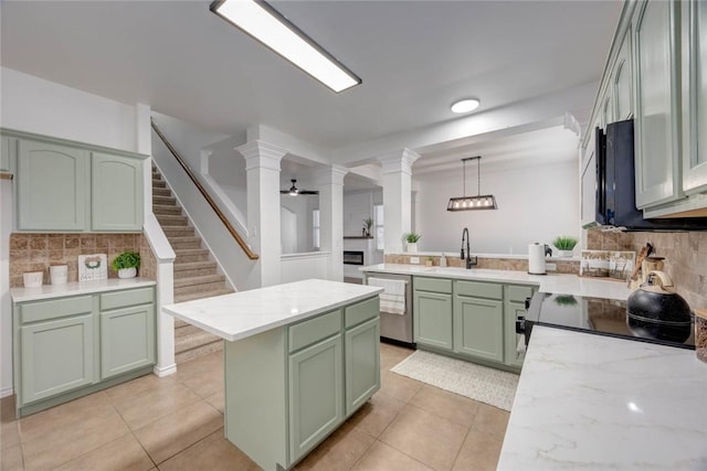 kitchen featuring decorative columns, stainless steel dishwasher, pendant lighting, and green cabinets