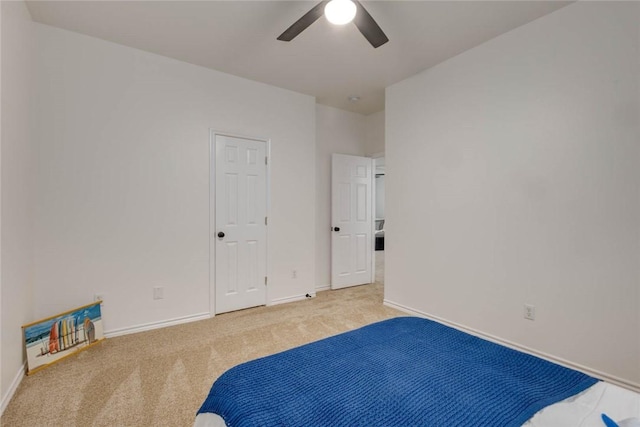 unfurnished bedroom featuring ceiling fan and carpet flooring