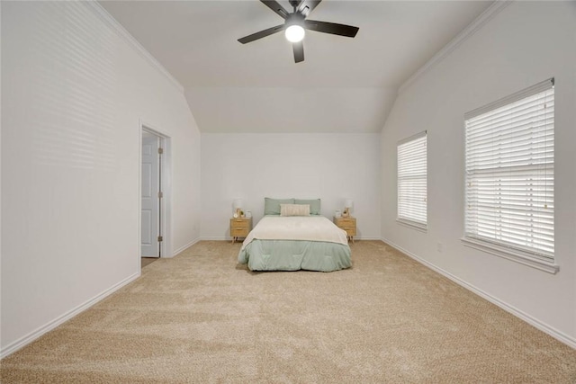 carpeted bedroom with ceiling fan, crown molding, and lofted ceiling