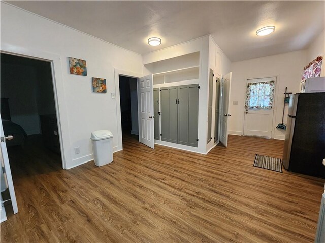 1613 6th St, Corpus Christi, TX 78404 - bedroom featuring freestanding refrigerator, wood finished floors, and baseboards
