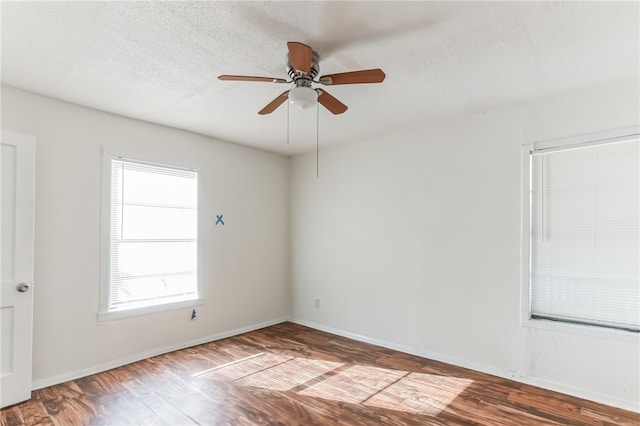 spare room with hardwood / wood-style floors, ceiling fan, and a textured ceiling