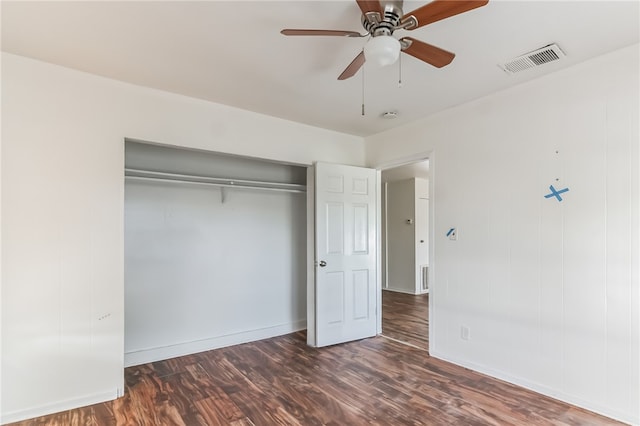 unfurnished bedroom featuring dark wood-type flooring, a closet, and ceiling fan