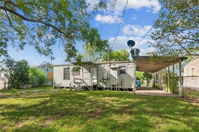 rear view of house featuring a yard