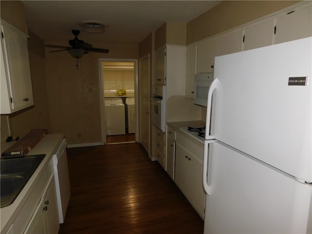 kitchen with white cabinetry, sink, dark hardwood / wood-style floors, independent washer and dryer, and white appliances