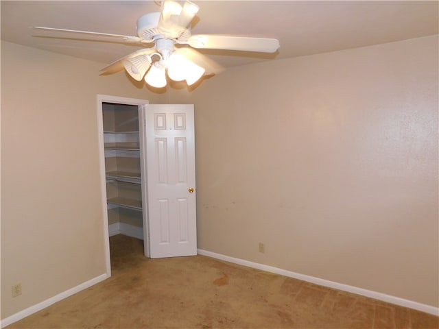 unfurnished bedroom featuring light colored carpet, ceiling fan, and a closet