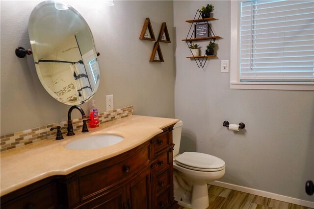 1508 Roosevelt Dr, Alice, TX 78332 - full bath with vanity, wood finished floors, a shower with shower curtain, and tasteful backsplash