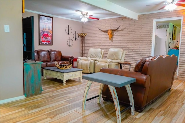 1508 Roosevelt Dr, Alice, TX 78332 - living room featuring a ceiling fan, brick wall, light wood finished floors, crown molding, and beam ceiling