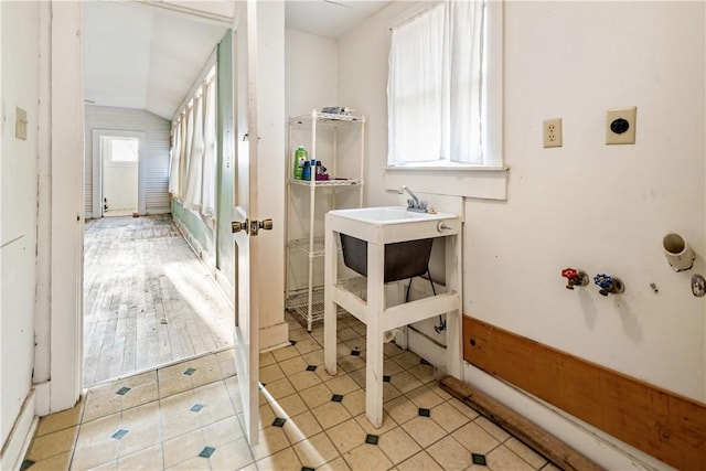 bathroom featuring vaulted ceiling and tile patterned floors