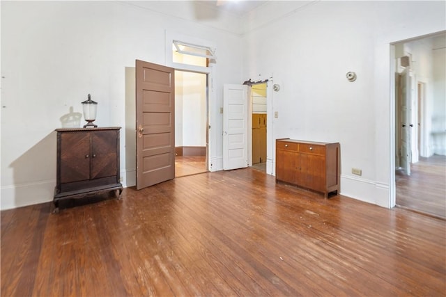 unfurnished room with wood finished floors and baseboards