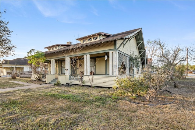 bungalow-style house featuring a porch and a front yard