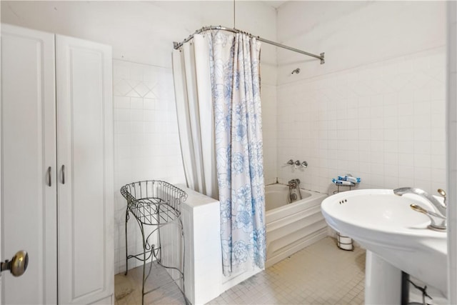bathroom with tile patterned floors, tile walls, and shower / bath combo