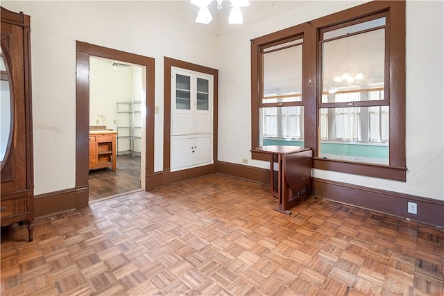 unfurnished room with baseboards