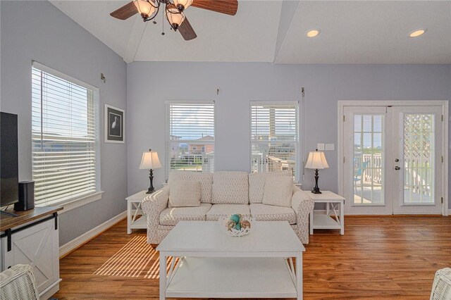 living area with light wood-style flooring, a ceiling fan, recessed lighting, french doors, and baseboards