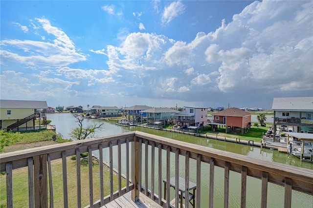 balcony with a residential view and a water view