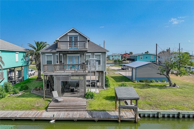 rear view of house featuring stairs, roof with shingles, a lawn, a balcony, and a deck with water view