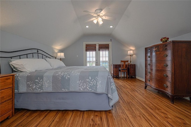 bedroom with access to exterior, baseboards, ceiling fan, vaulted ceiling, and wood finished floors