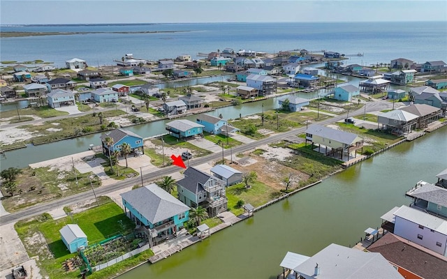 drone / aerial view with a residential view and a water view