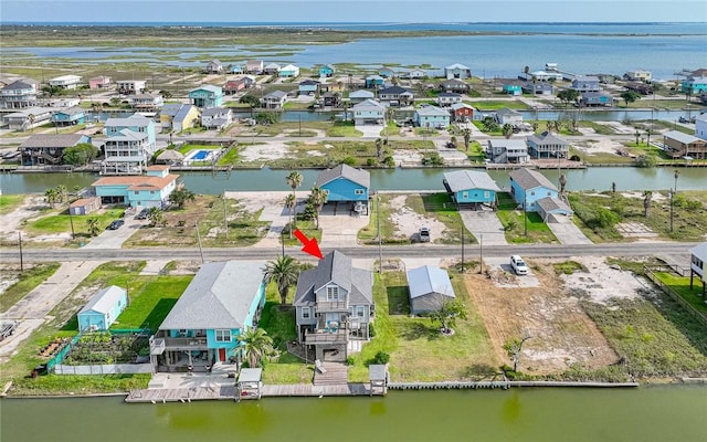 birds eye view of property with a residential view and a water view