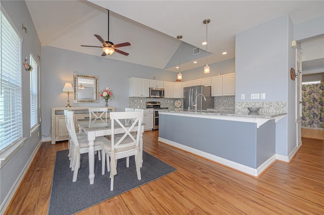 dining room with recessed lighting, baseboards, light wood-type flooring, and ceiling fan