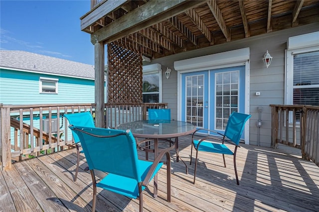 deck featuring outdoor dining space and french doors