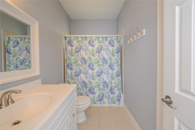 bathroom with tile patterned floors, toilet, vanity, and a shower with curtain