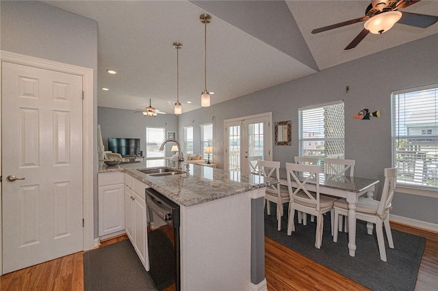 kitchen featuring a sink, vaulted ceiling, black dishwasher, french doors, and open floor plan