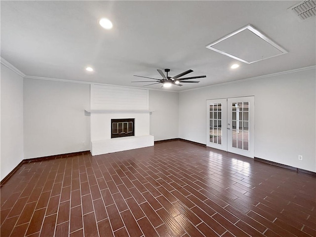 unfurnished living room featuring attic access, visible vents, dark wood finished floors, french doors, and a fireplace