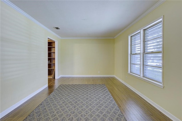 unfurnished room with hardwood / wood-style floors and ornamental molding