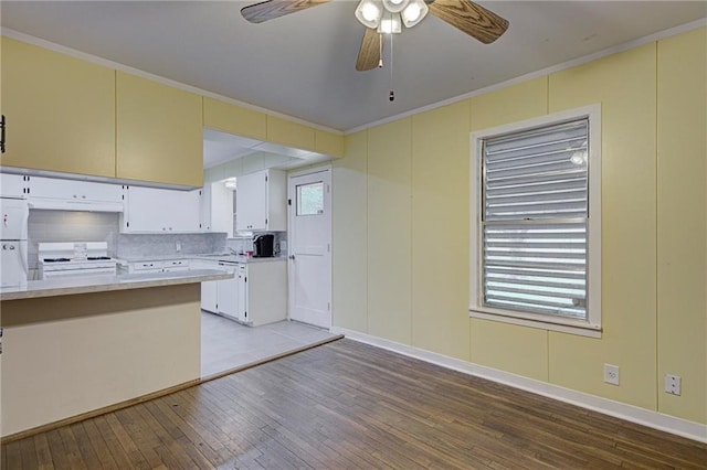 kitchen featuring light hardwood / wood-style floors, white cabinetry, tasteful backsplash, white appliances, and crown molding