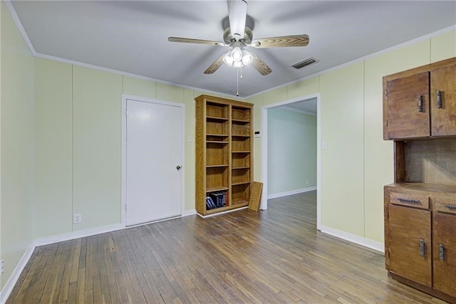 interior space featuring ornamental molding, wood-type flooring, and ceiling fan