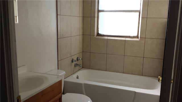 full bathroom featuring vanity, toilet, and tiled shower / bath