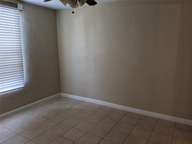 unfurnished room featuring ceiling fan and light tile patterned floors