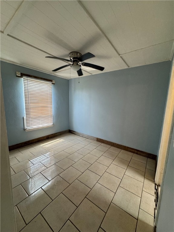 spare room with ceiling fan and light tile patterned floors