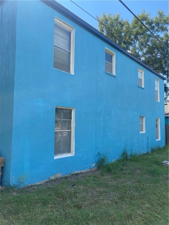 view of side of home with a lawn