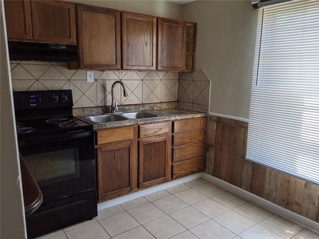 kitchen with sink, black electric range oven, range hood, wood walls, and decorative backsplash