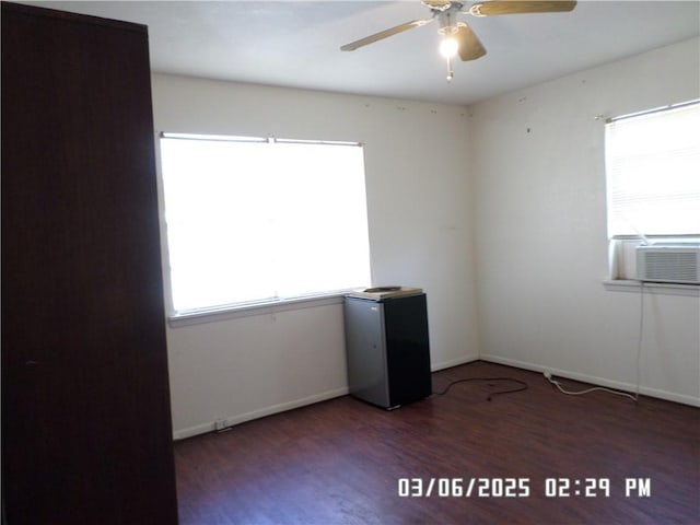 unfurnished room with cooling unit, baseboards, a ceiling fan, and wood finished floors