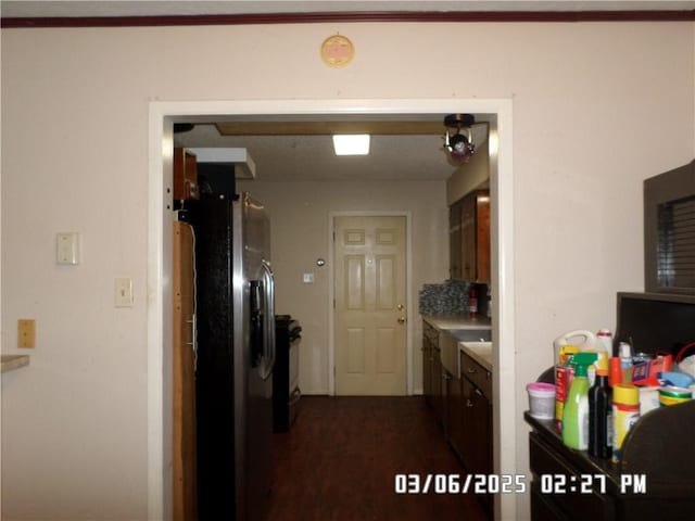 kitchen featuring refrigerator with ice dispenser, light countertops, and dark wood-type flooring