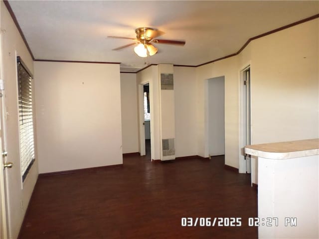 unfurnished room featuring ceiling fan, baseboards, dark wood-style flooring, and ornamental molding