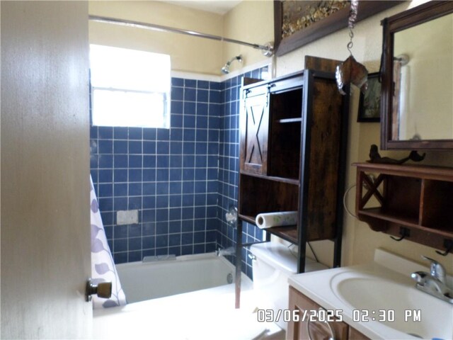 full bath with toilet, vanity, and shower / tub combo